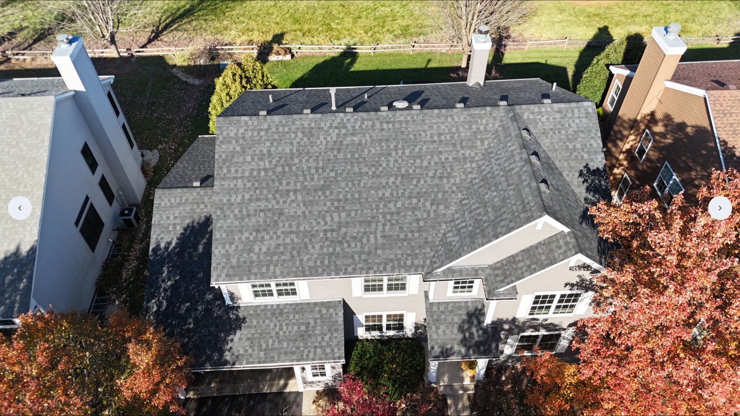Aerial drone view of a completed gray architectural shingle roof