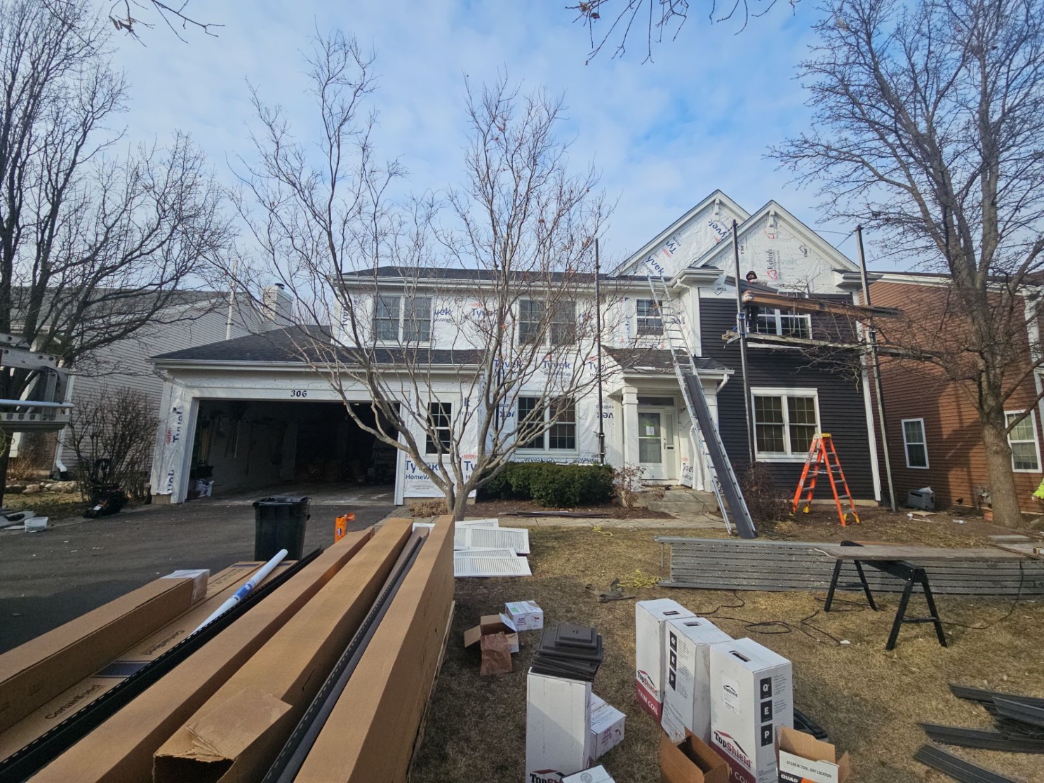 DFW home mid roof and exterior restoration with materials staged